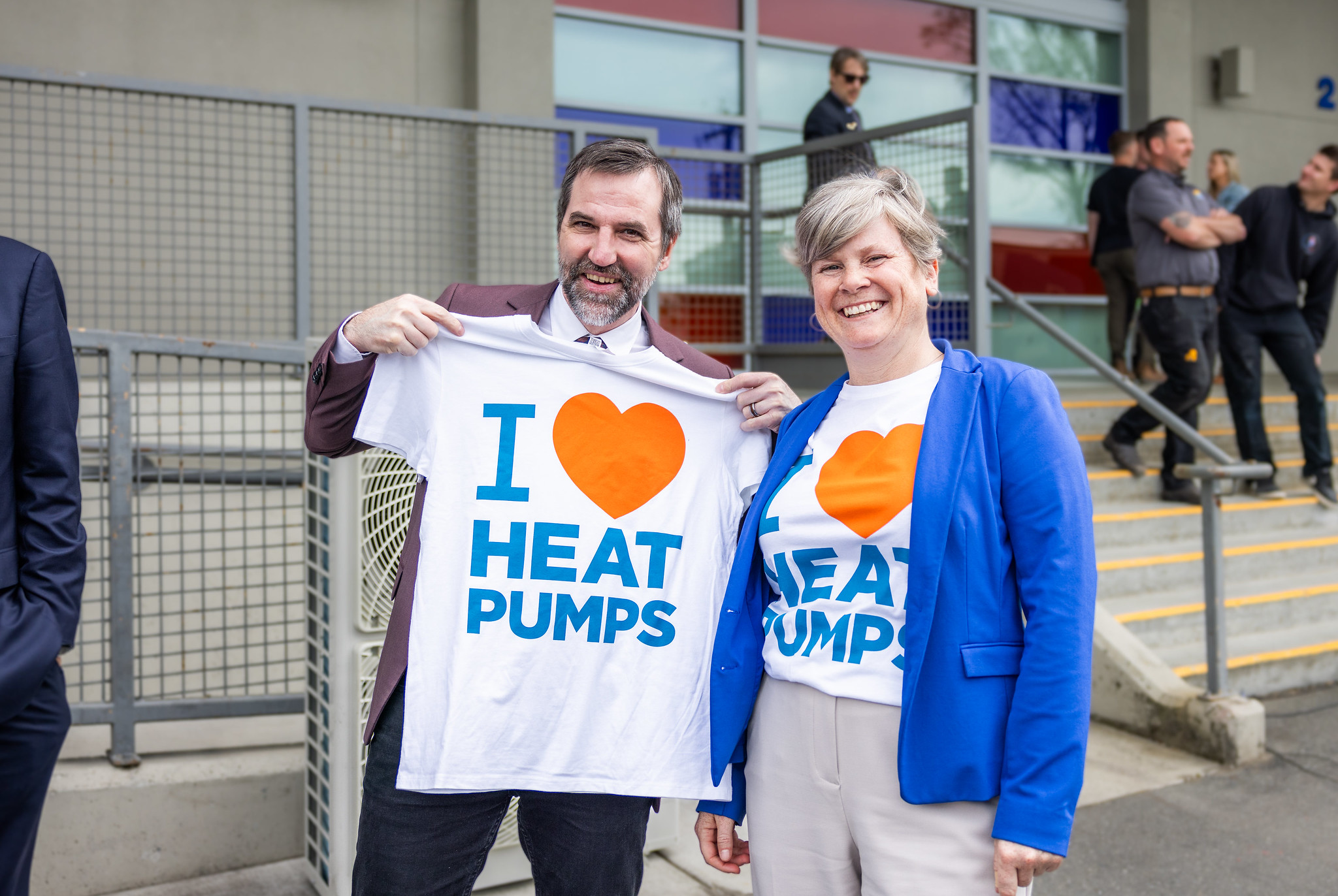 image of two folks holding up I love heat pump shirts